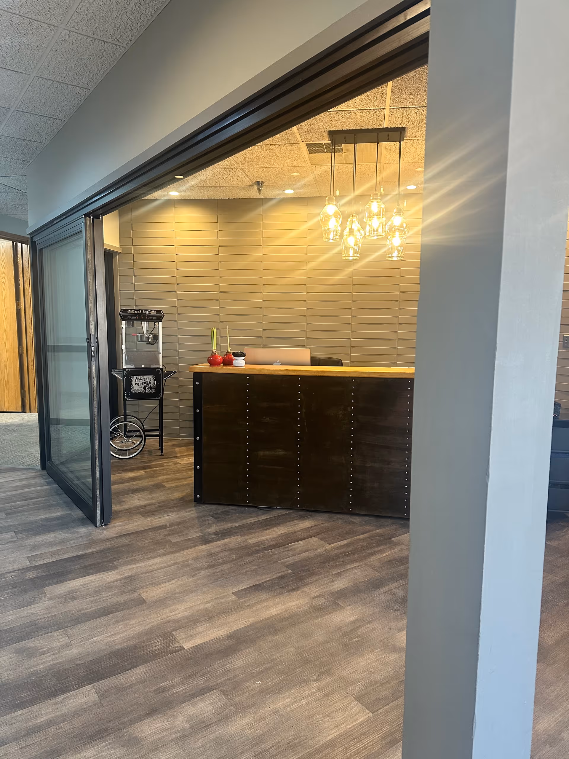 Modern reception desk with pendant lights inside a senior facility lobby