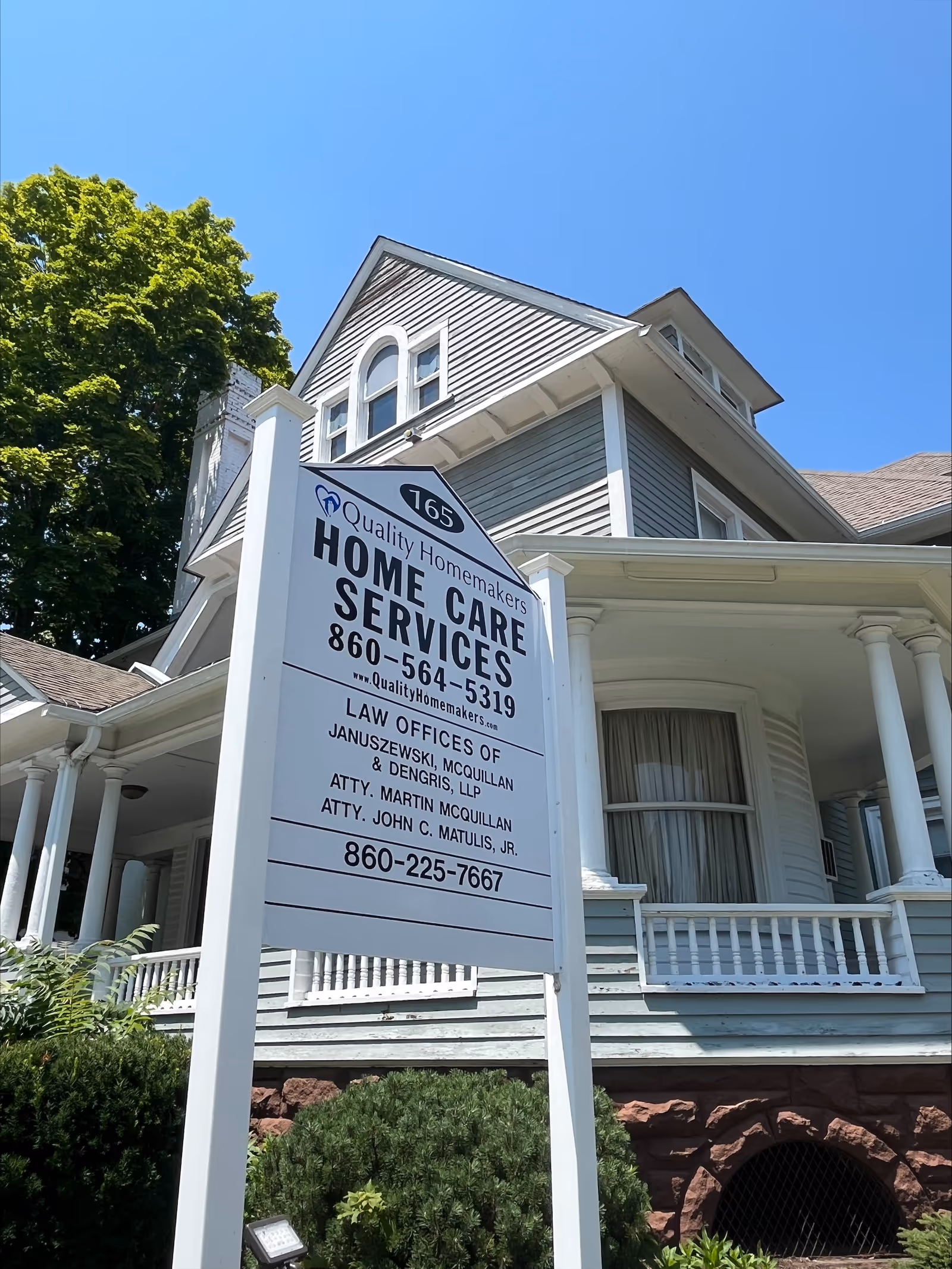 Two-story home-style building with a large sign advertising home care services.