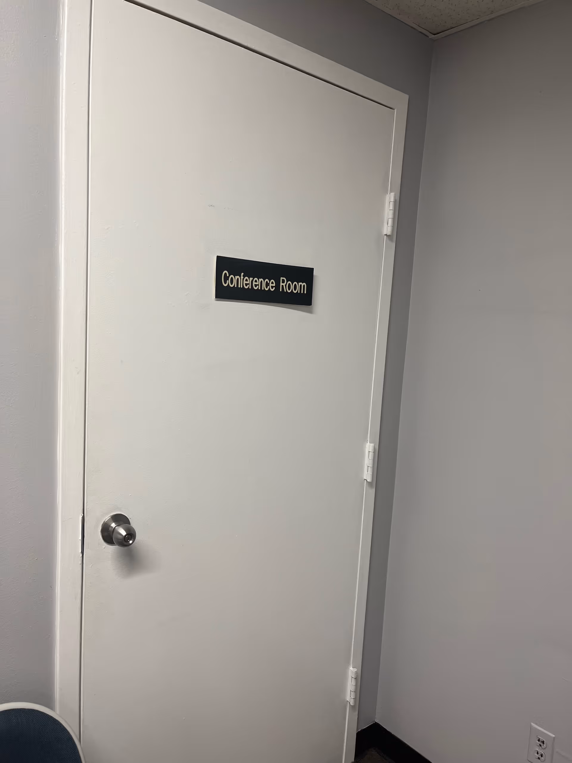 White interior door labeled Conference Room in a hallway.