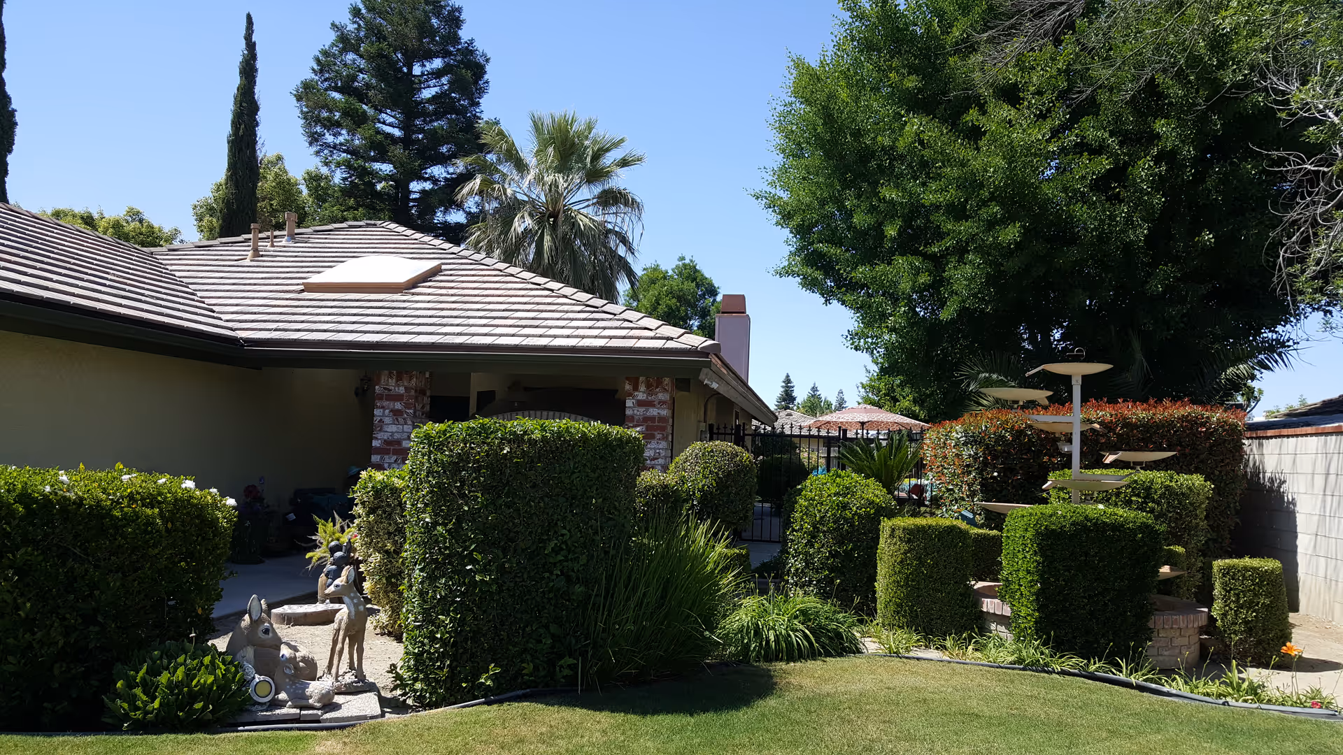 Golden Hearts Residential Care Facility exterior with trimmed hedges and a courtyard.