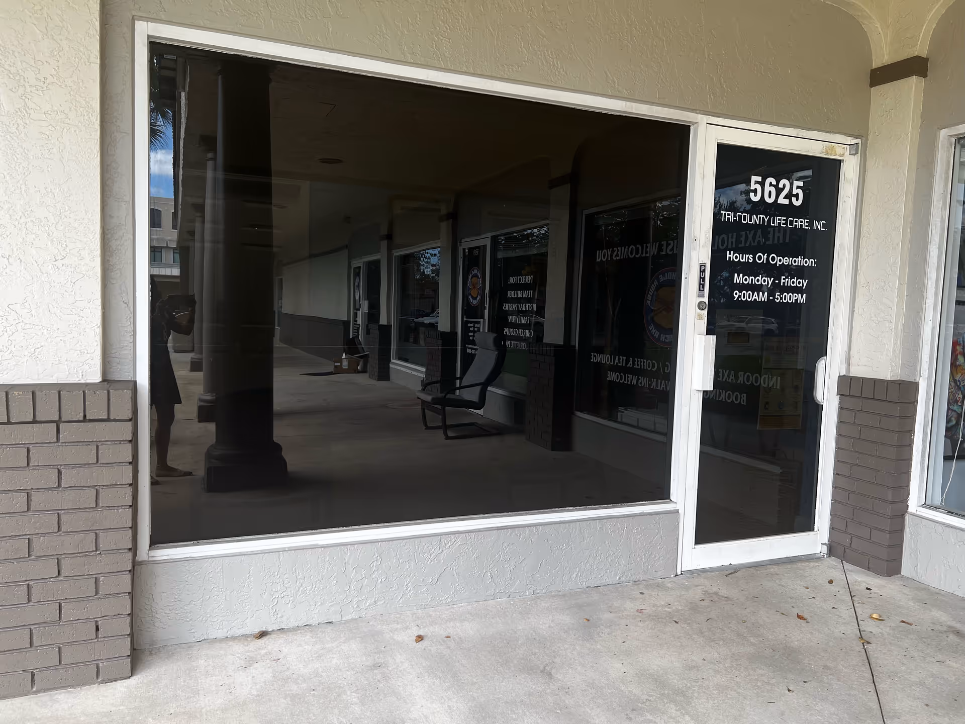 Exterior storefront of Tri-County Life Care with glass doors and bench visible.