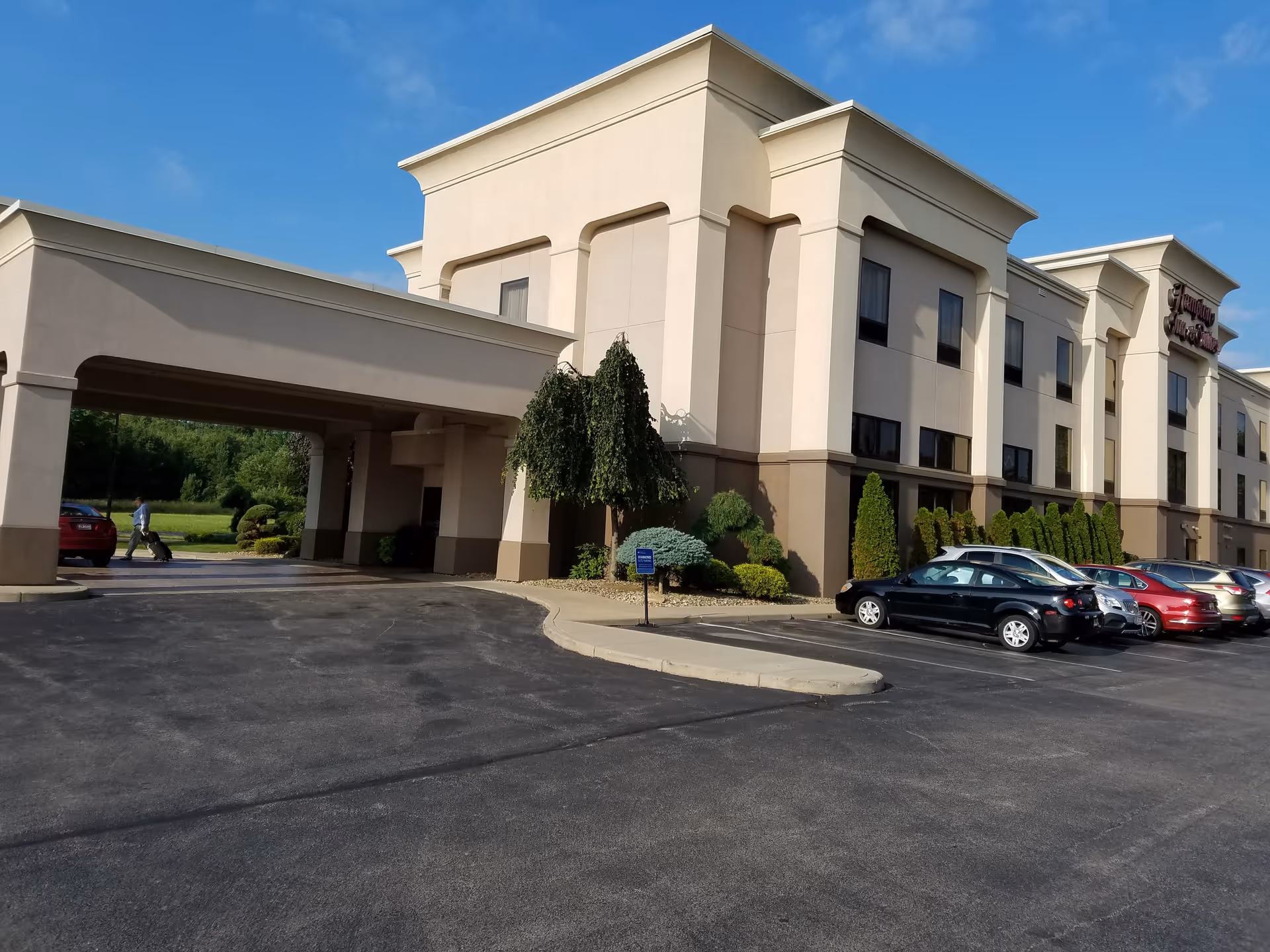 Exterior view of The Inn at Ironwood, a multi-story senior living facility with parked cars