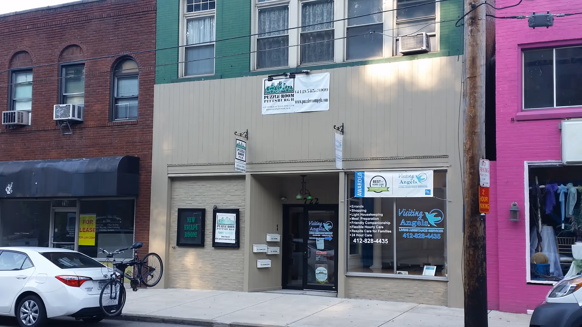 Beige storefront with Visiting Angels signage and glass door in Monroeville