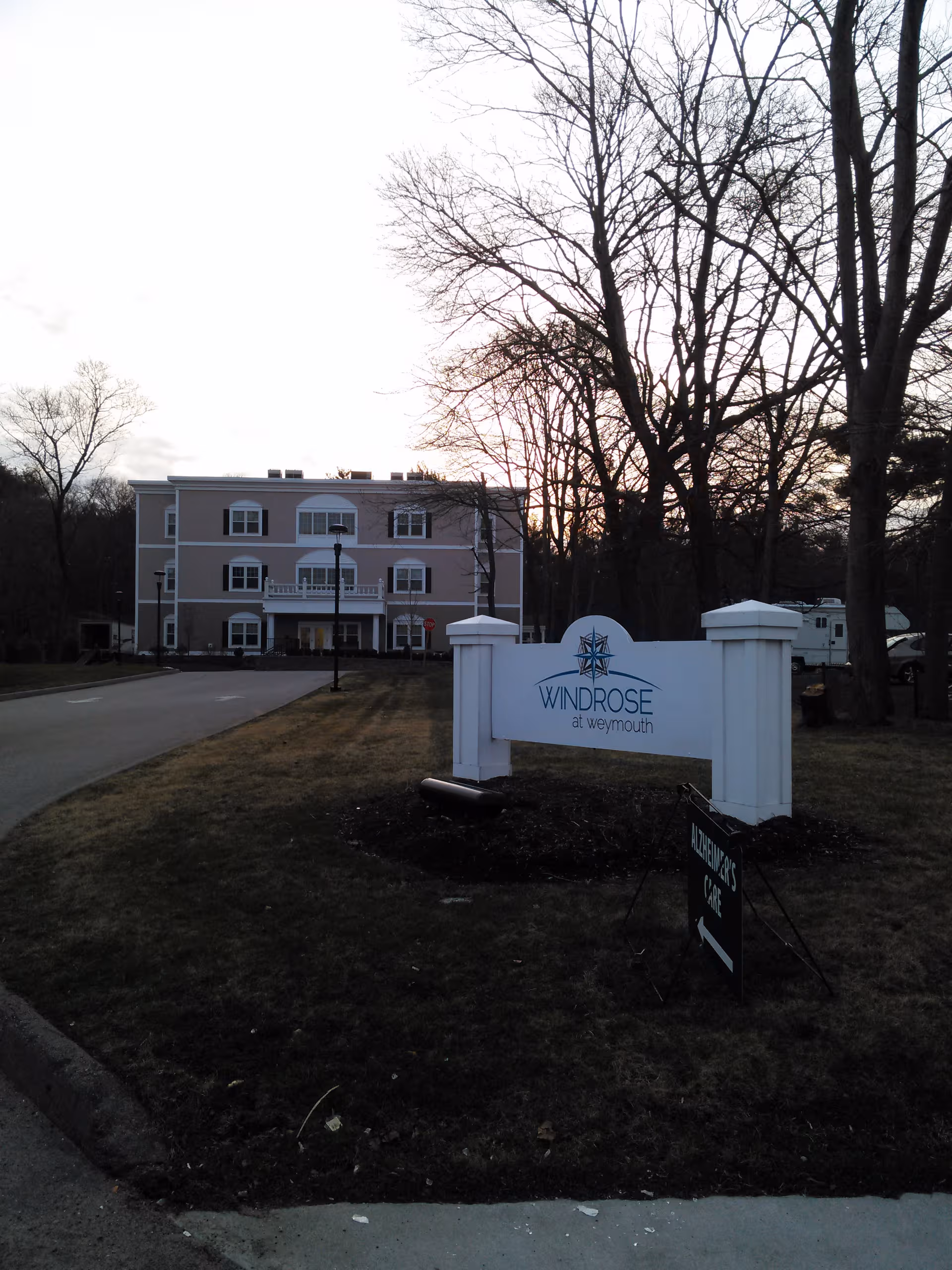 Exterior view of Windrose at Weymouth facility with sign, entrance, and trees