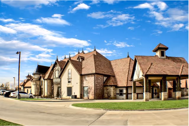Exterior view of The Highlands at Owasso, a multi-wing building with a curved driveway.