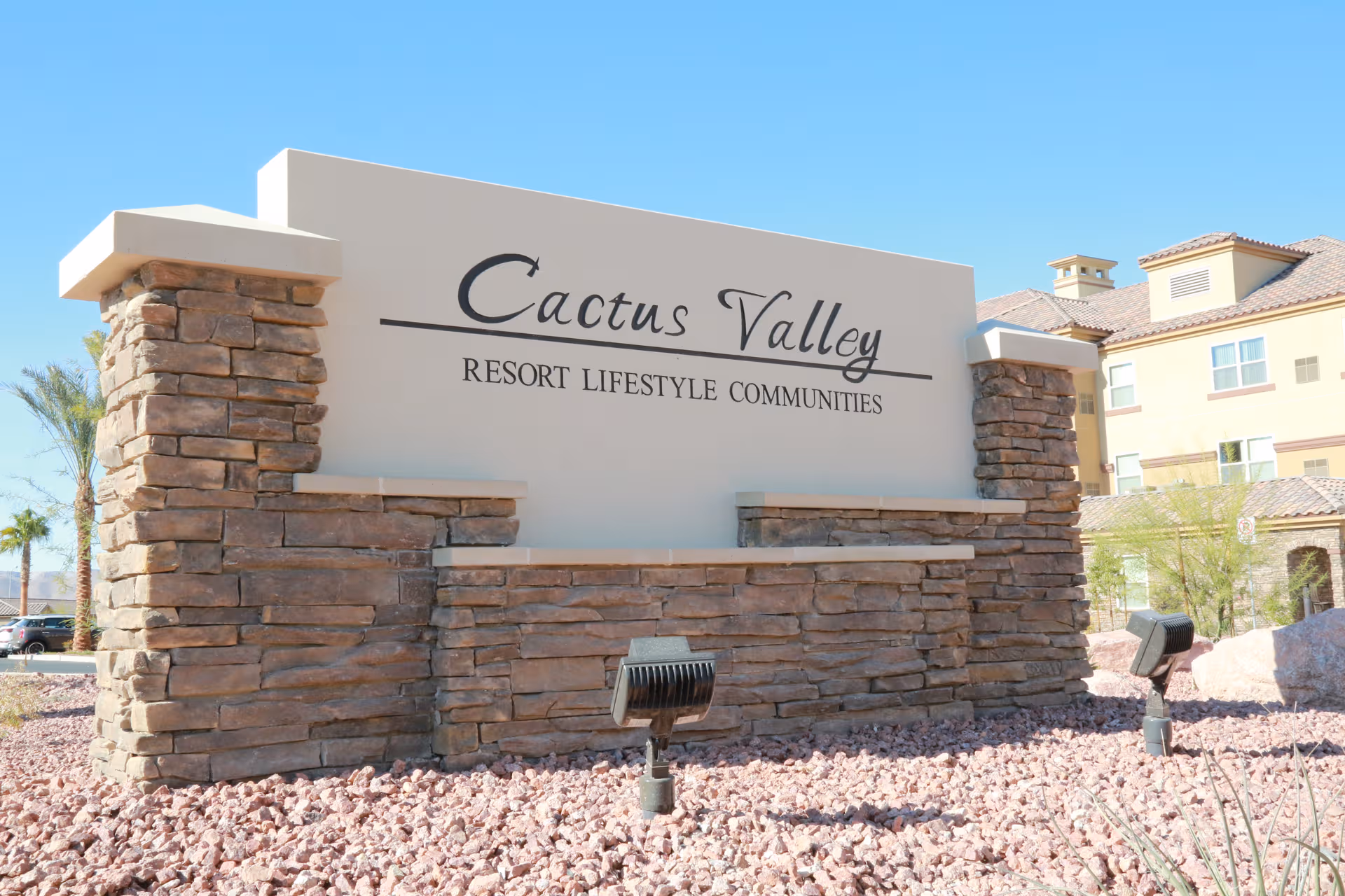 Front entrance sign reads Cactus Valley Resort Lifestyle Communities with stone facade.