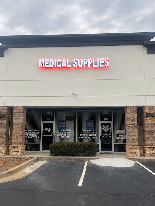 Exterior storefront displaying Medical Supplies sign with glass doors and parking lot.