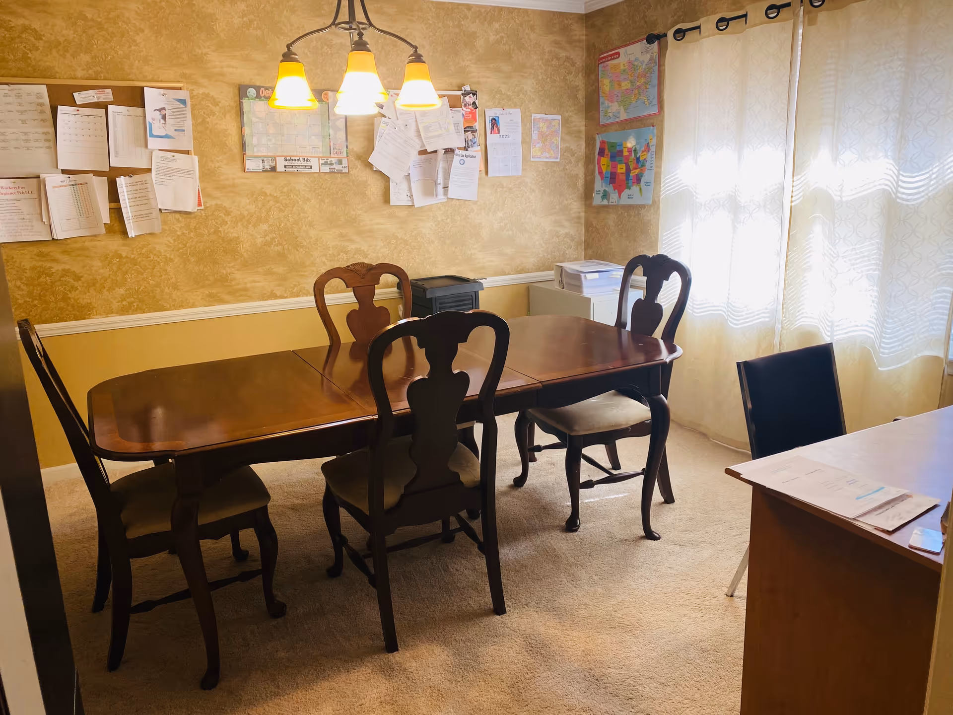 Wood dining table with chairs in a warm senior living dining room