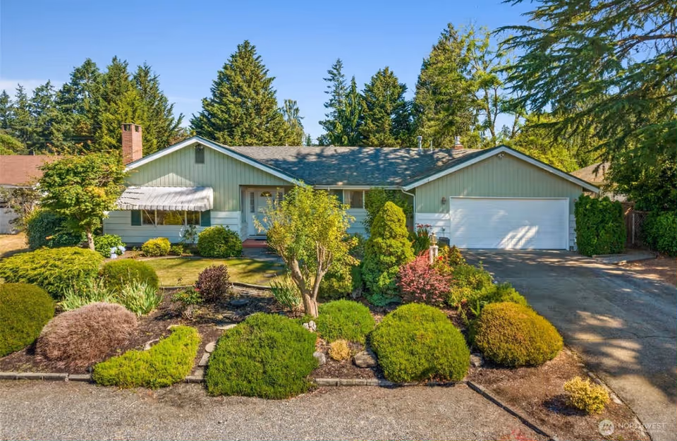 Front view of Radiant Care Adult Family Home with landscaped yard and two-car garage.