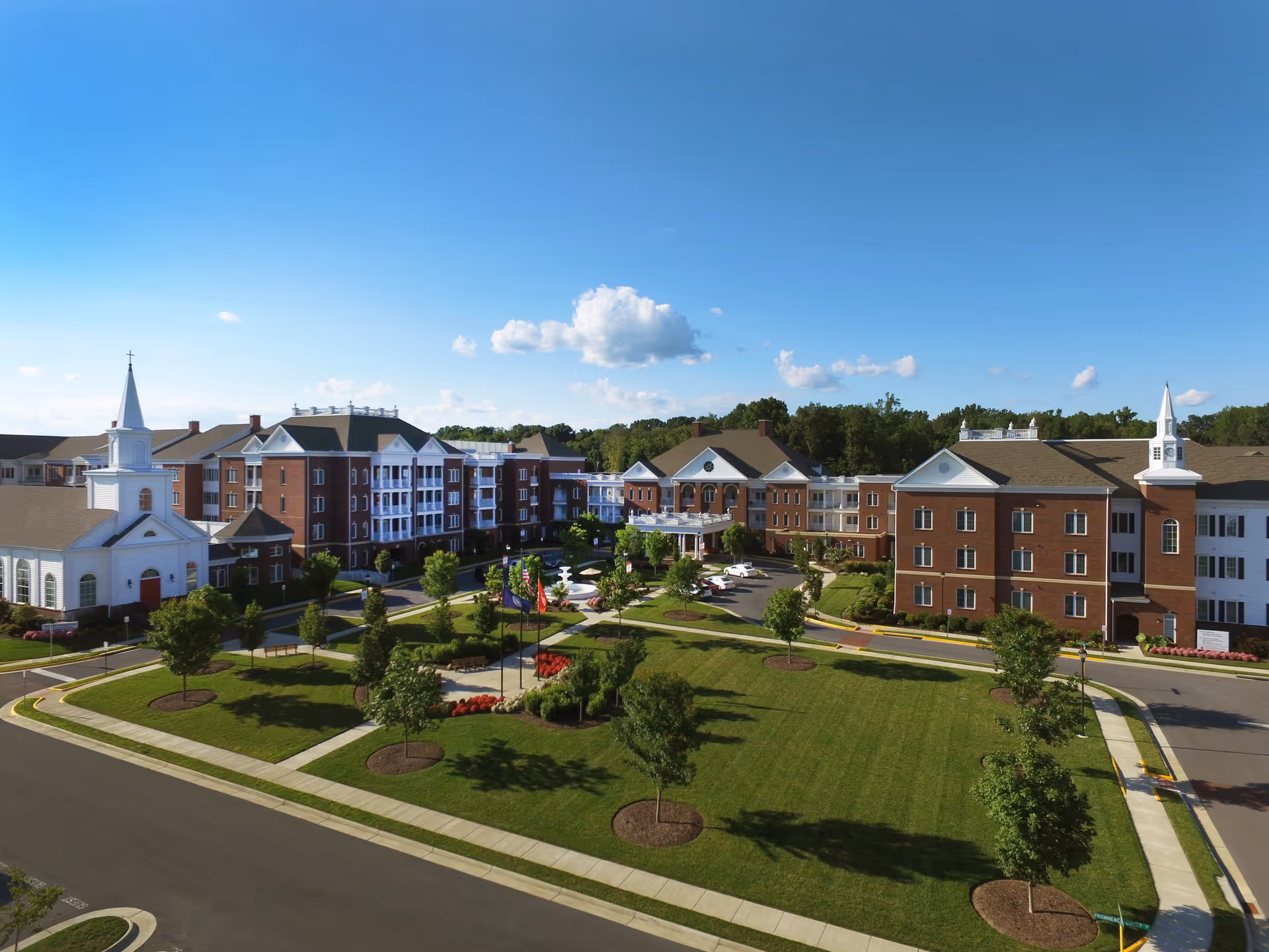Exterior view of The Village at Orchard Ridge, a senior living campus with brick buildings.