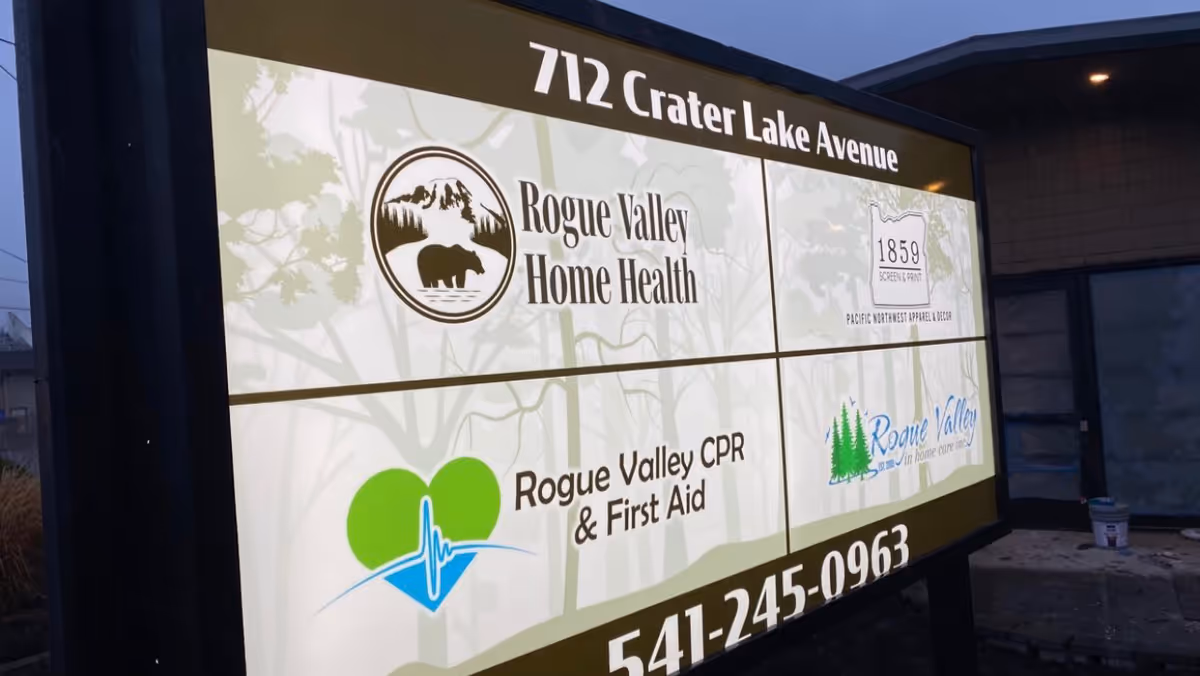 Outdoor signboard displays Rogue Valley Home Health logos and address at 712 Crater Lake Avenue.