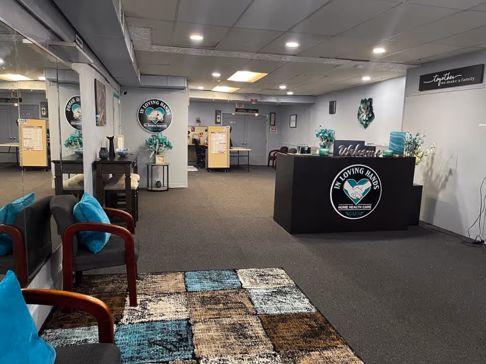 Lobby reception area featuring a logo desk, teal accents, and seating.