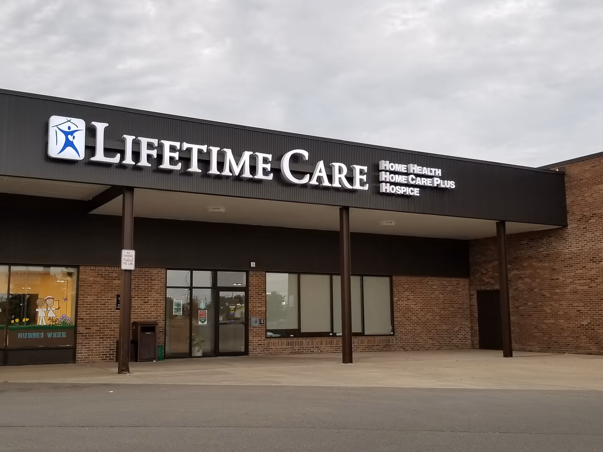 Exterior view of a Lifetime Care building with large sign and service labels.
