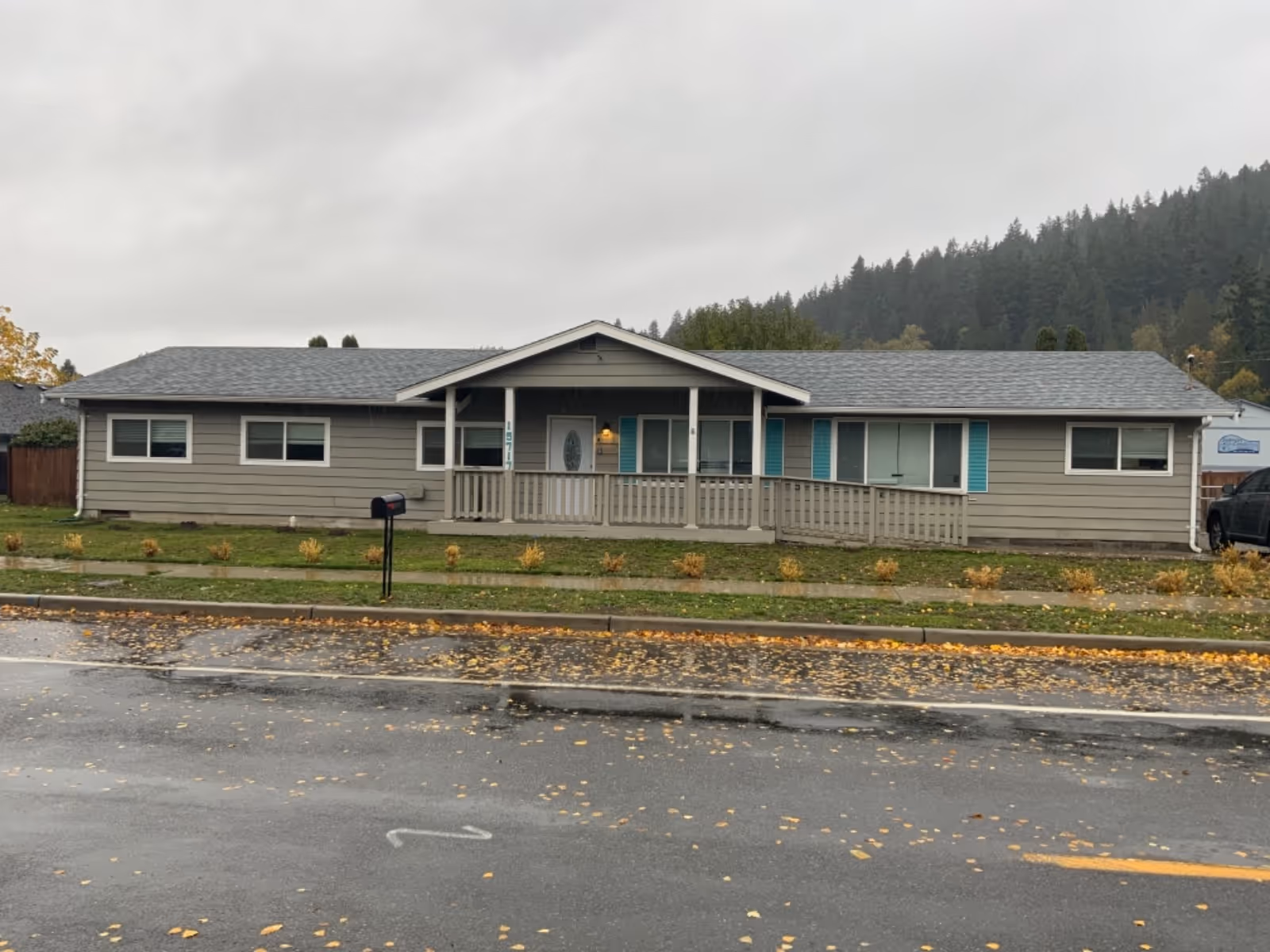 Single-story senior living facility with a front porch and a landscaped front yard.