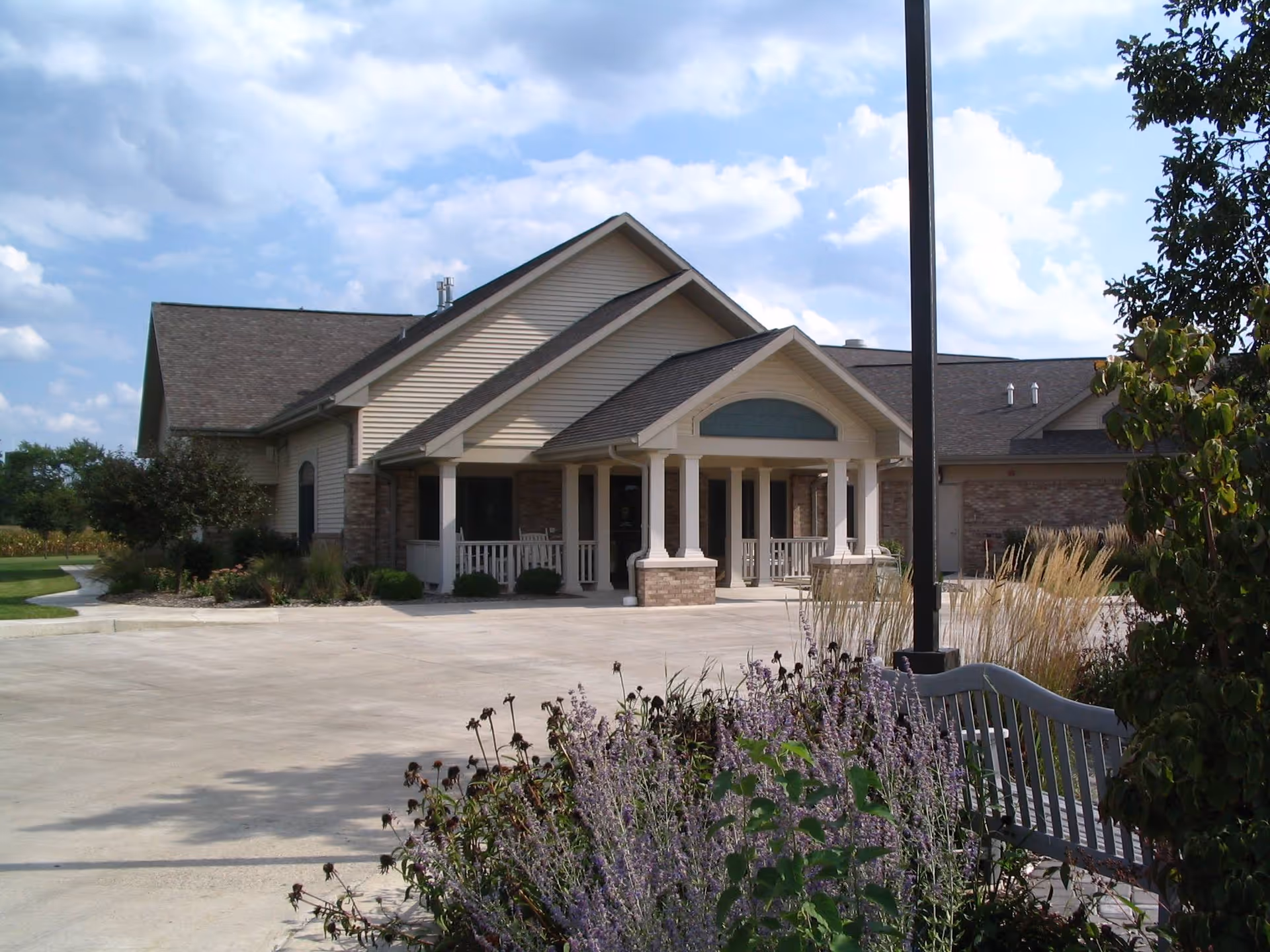 Exterior view of Evenglow Inn with a covered entrance and landscaped front.