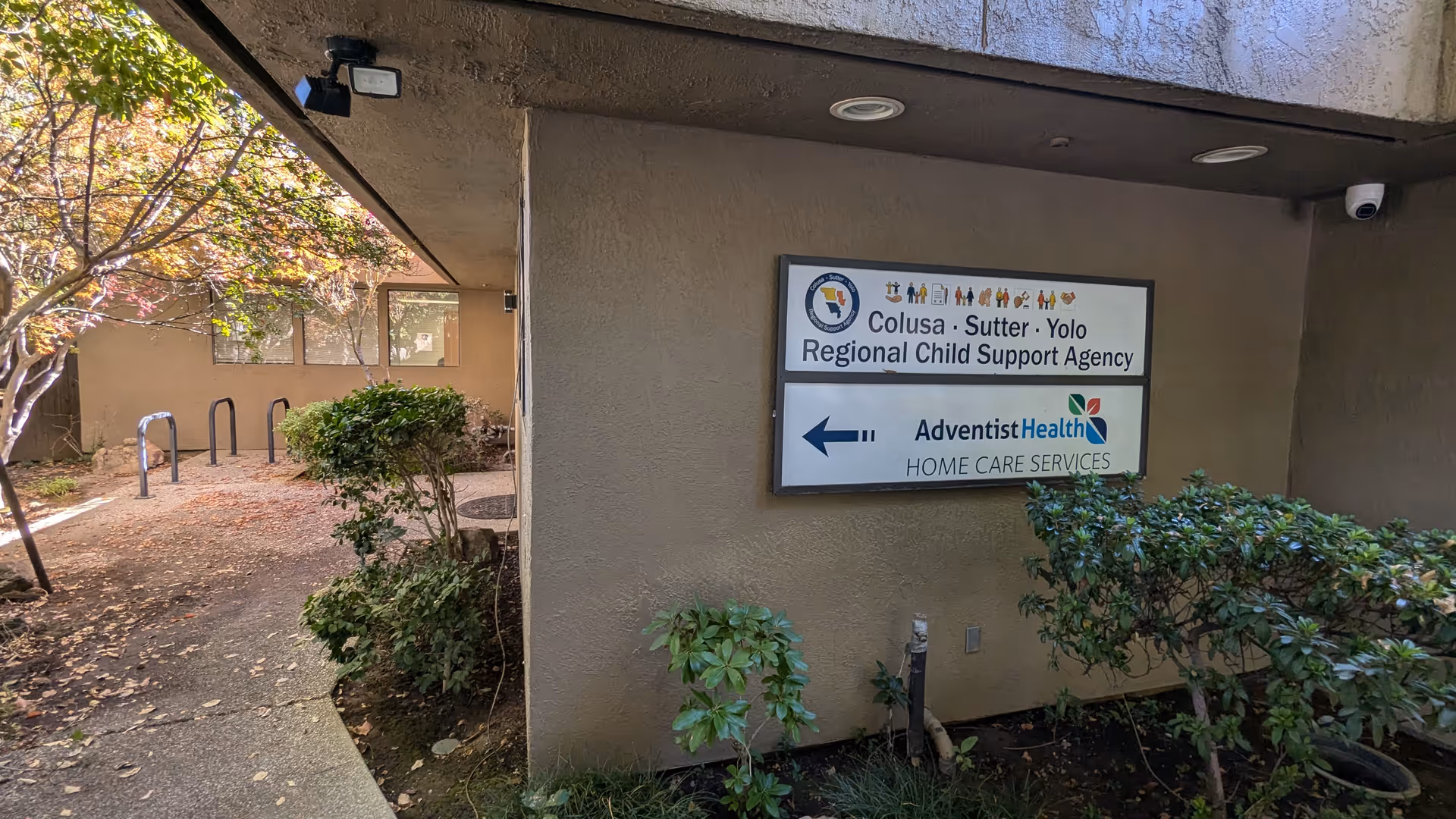 Exterior view of a building entrance with an Adventist Health Home Care Services sign.