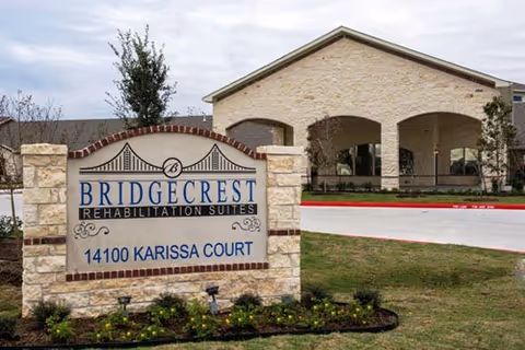 Bridgecrest Rehabilitation Suites sign in front of a brick building exterior.