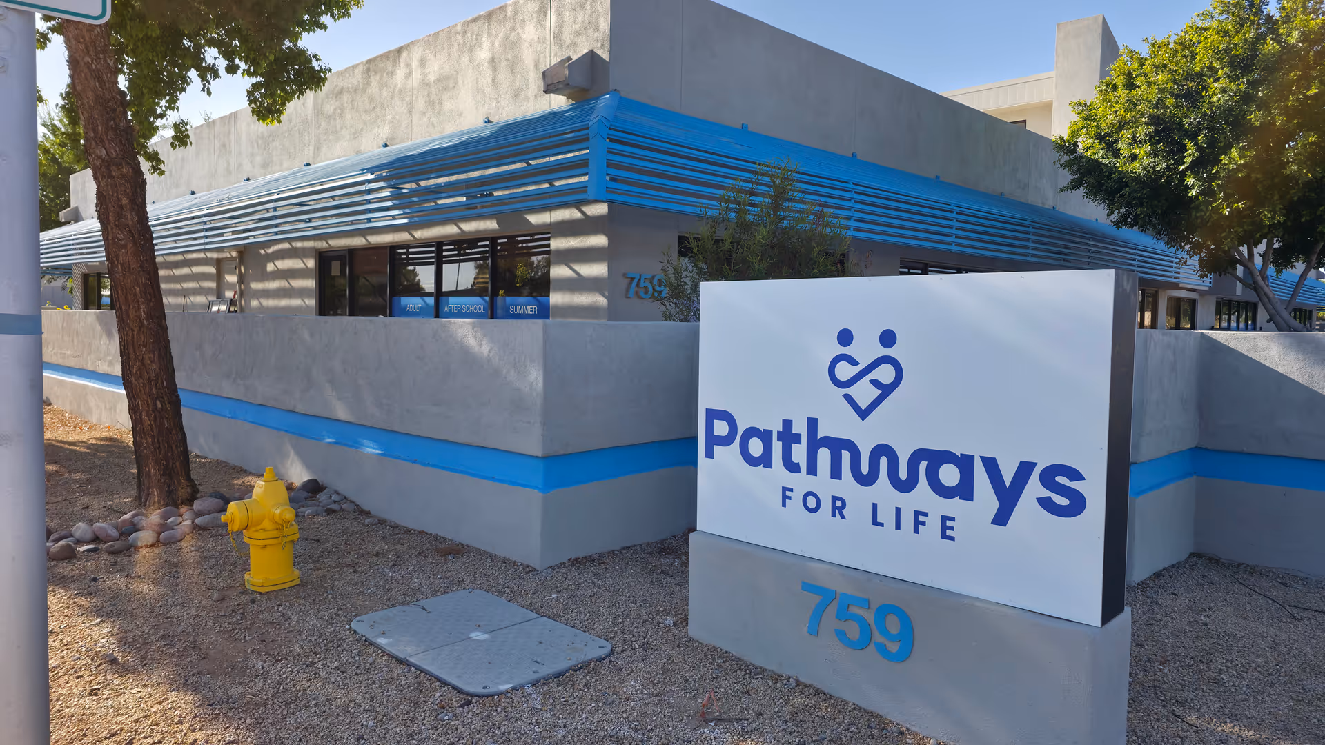 Exterior view of Pathways for Life Mesa building with blue accents and large sign