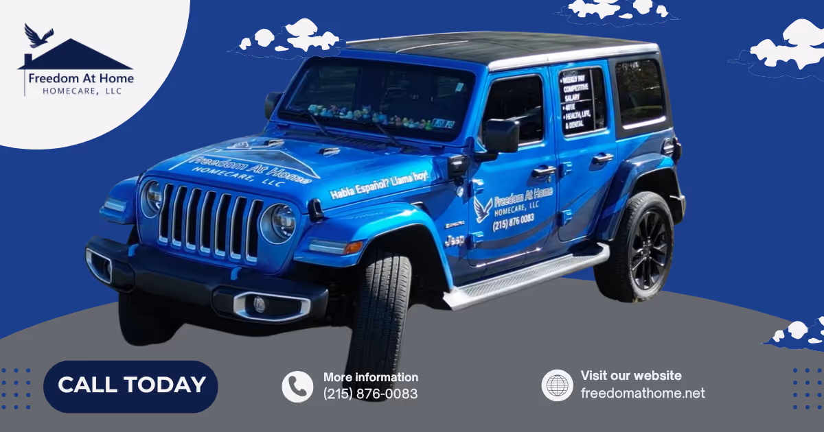 Blue Jeep Wrangler branded with Freedom At Home HomeCare LLC logo and contact info.