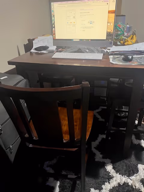 Desk with computer monitor and papers in a care facility office interior.