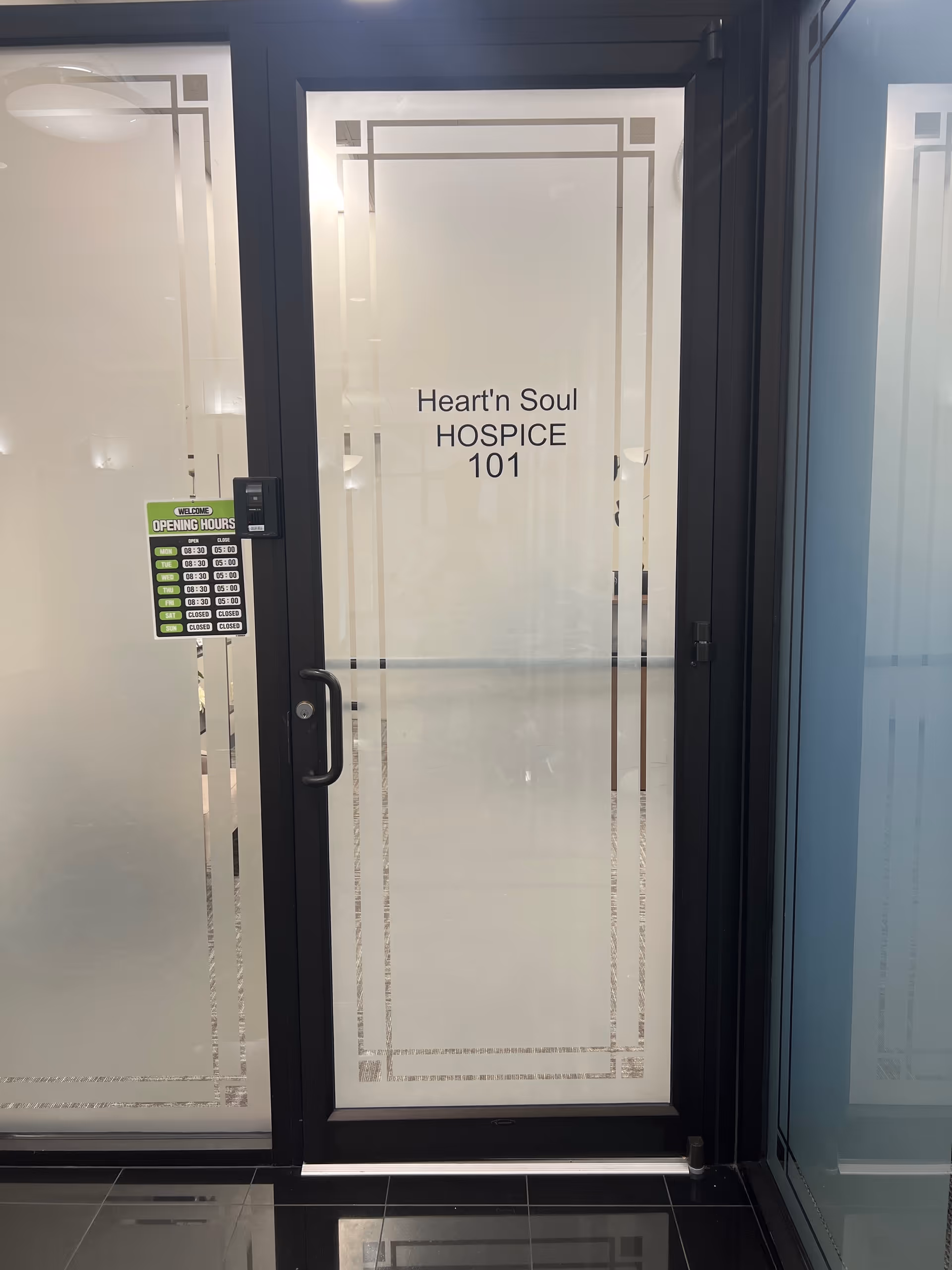 Frosted glass door reading Heart'n Soul Hospice 101 in a hallway.