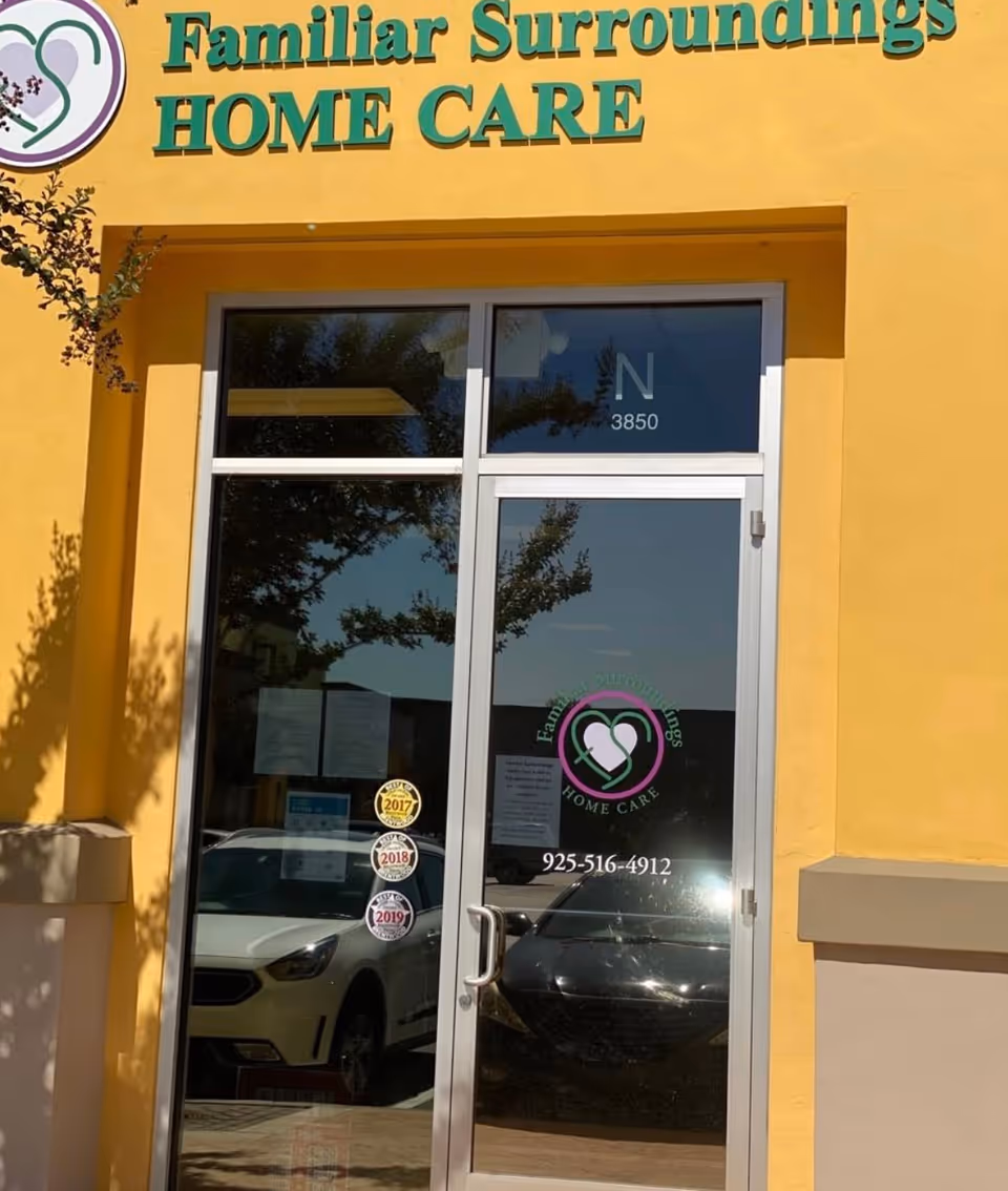 Yellow exterior building with glass entrance door and Familiar Surroundings Home Care signage.