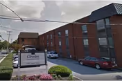 Exterior view of Cliveden Nursing and Rehabilitation Center with brick facade and parked cars.