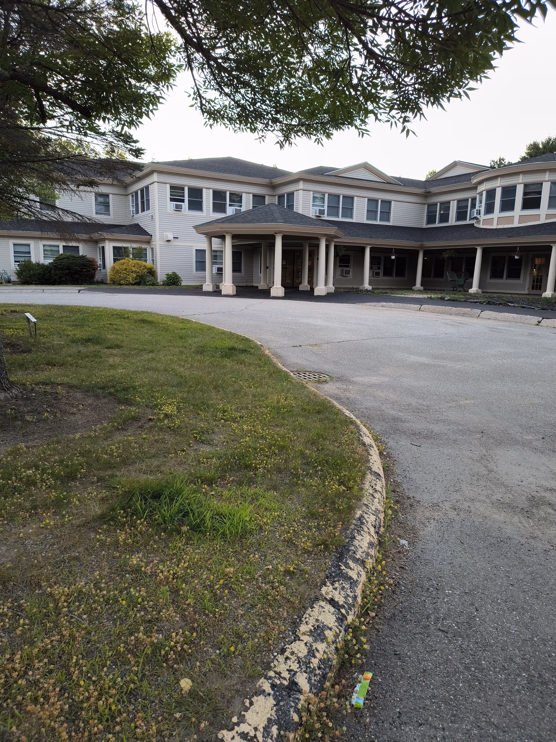 Windward Gardens senior living facility exterior with curved driveway and entrance canopy