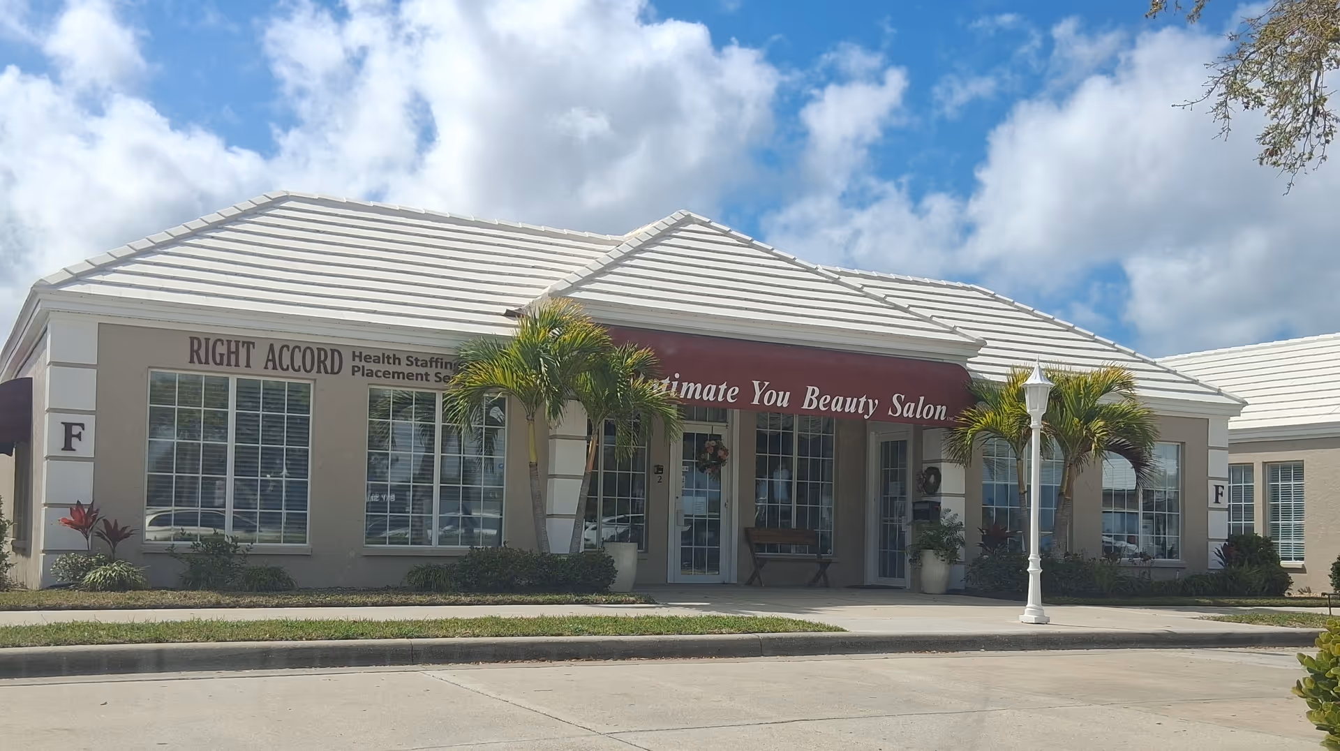 Right Accord storefront: a single-story beige building with palm trees and maroon canopy.