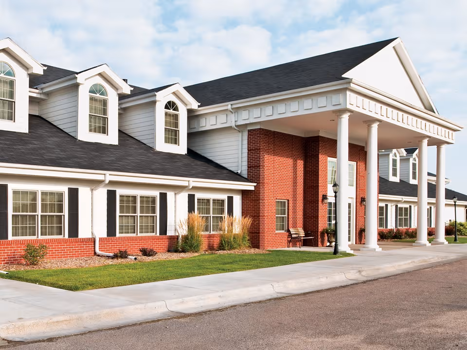 Exterior view of The Heritage at College View with brick facade and portico entrance.