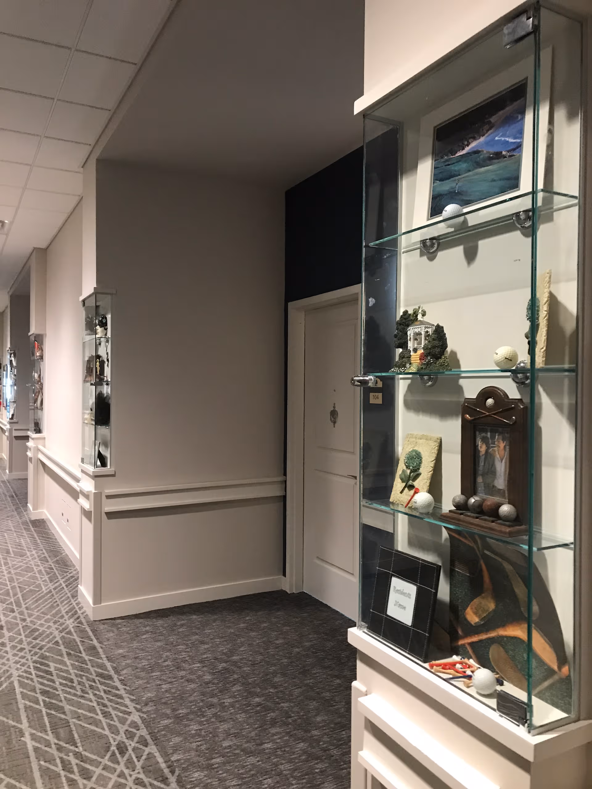 Hallway inside StoryPoint Bolingbrook with display shelves and decorative items along the wall.
