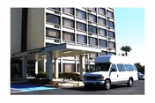 Exterior view of St Mark's Towers with a white van parked at the entrance.