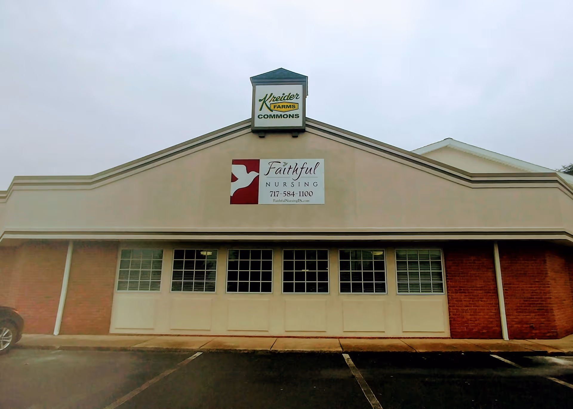 Front exterior of a beige nursing facility with Faithful Nursing sign and Kreider Farms sign.