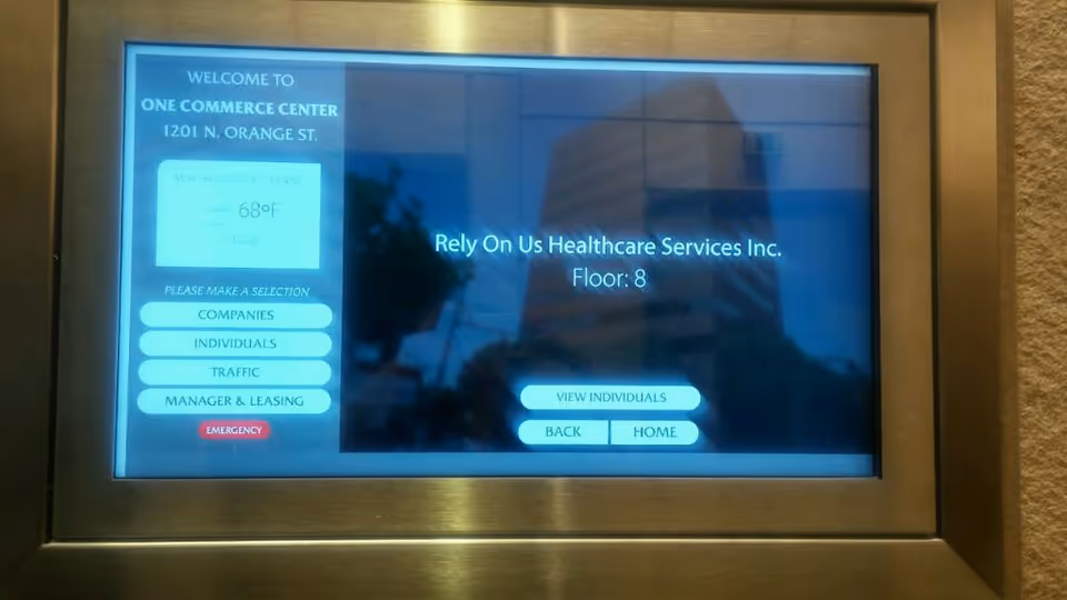 Elevator lobby directory screen shows Rely On Us Healthcare Services, Floor 8.