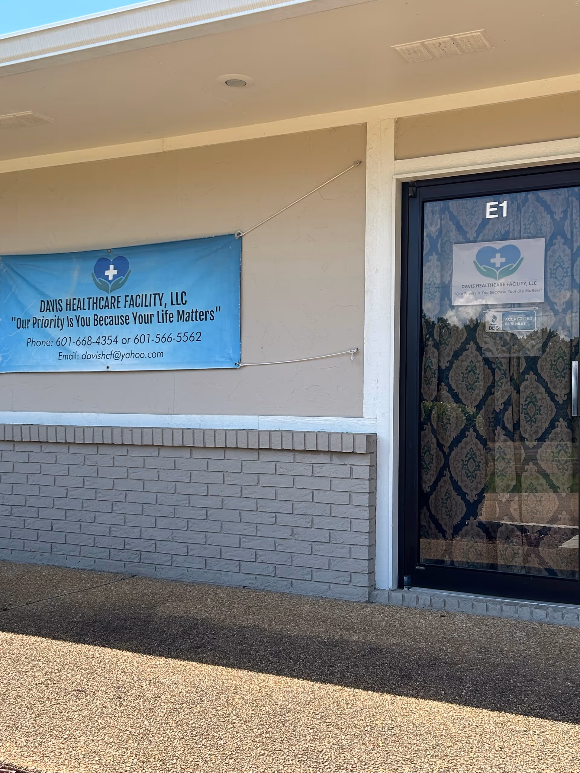 Exterior view of a Davis Healthcare Facility entrance with a blue banner.