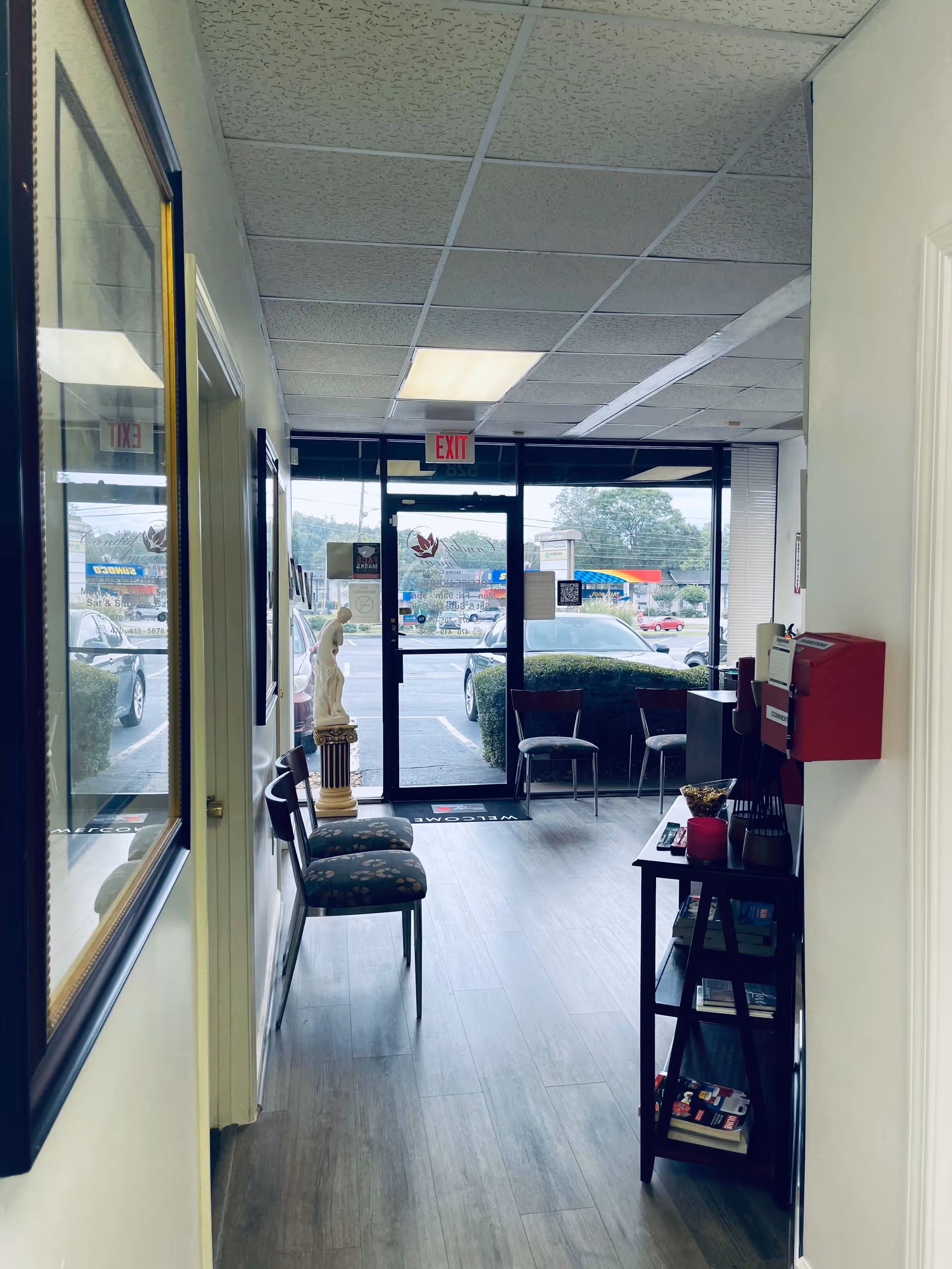 Interior waiting area of a senior care facility with glass doors and chairs at the entrance.