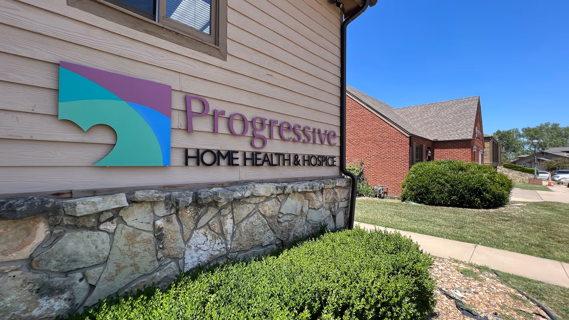 Exterior view of Progressive Home Health & Hospice building with sign and landscaping.