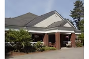 Front exterior of Pinewood Terrace with brick columns and a covered entrance.