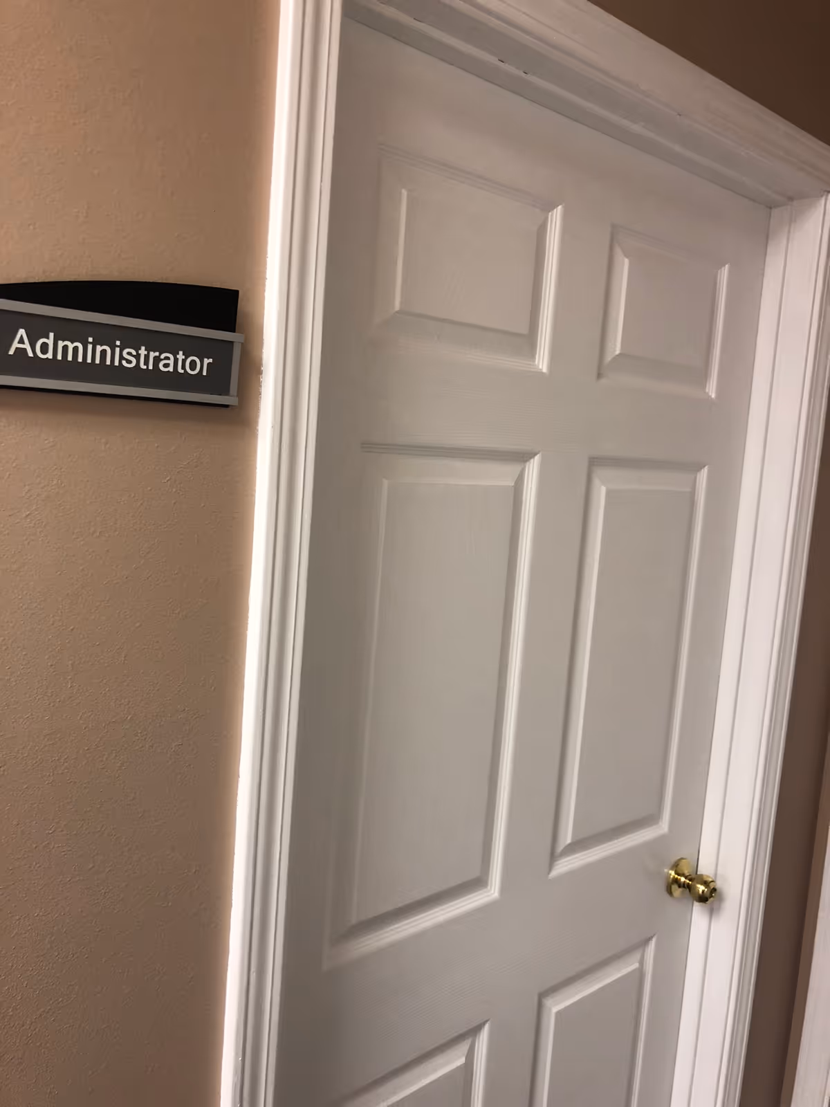 Interior hallway with a white door labeled Administrator.