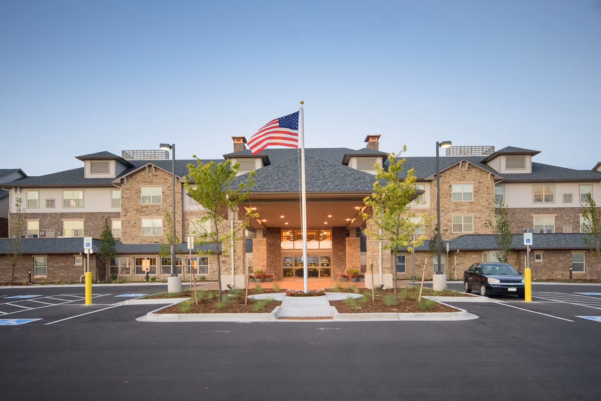 Front view of Parkside Village Retirement Resort with entrance, flagpole, and parking.