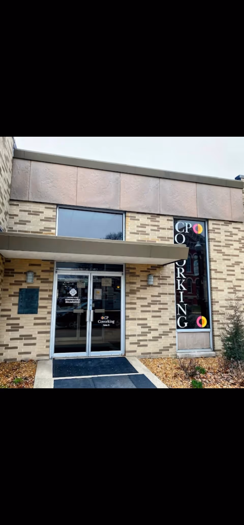 Brick building entrance with glass doors and vertical signage for Skyyann's Health Care INC.