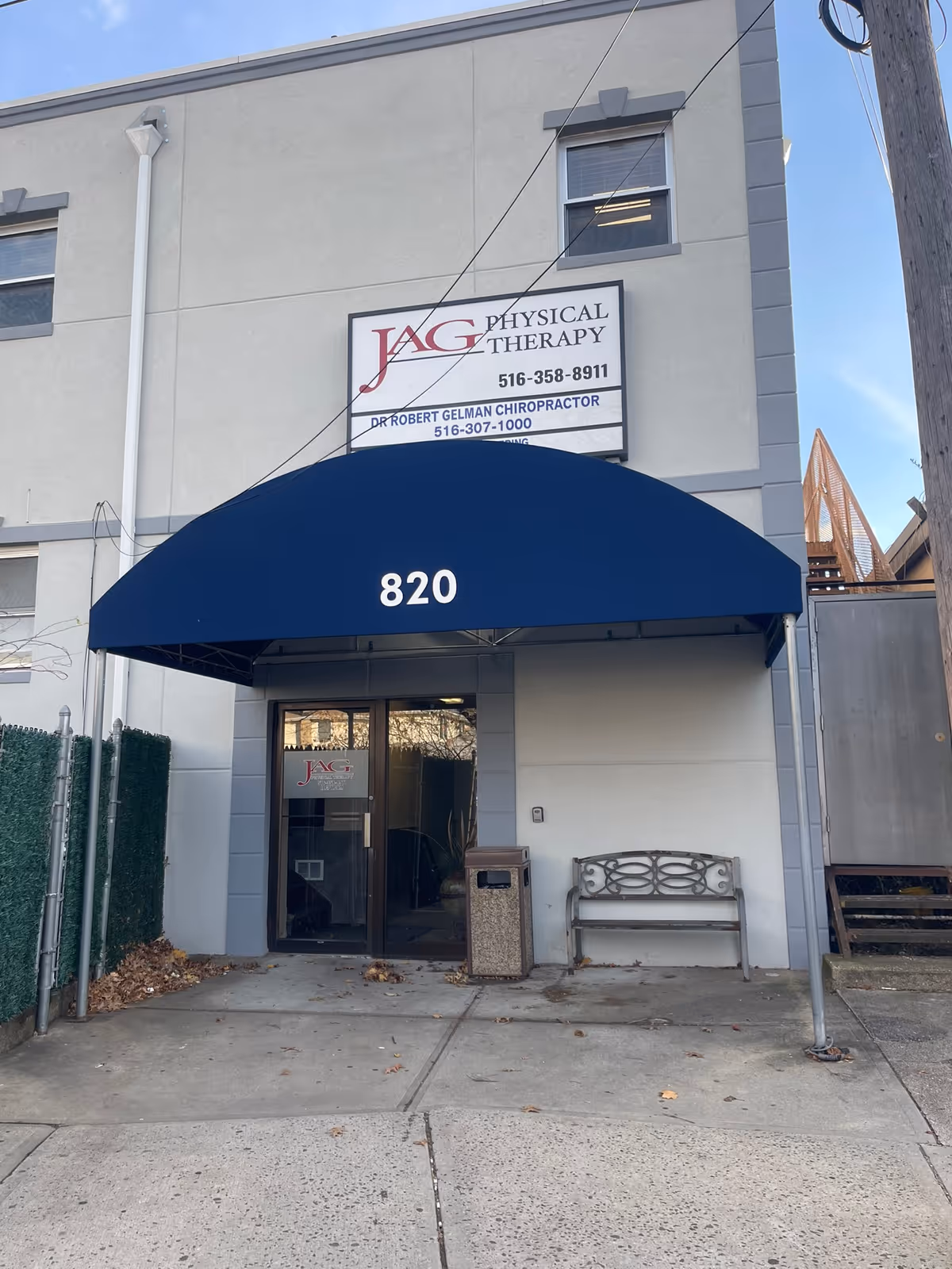 Exterior front of JAG Physical Therapy building with blue awning displaying 820.