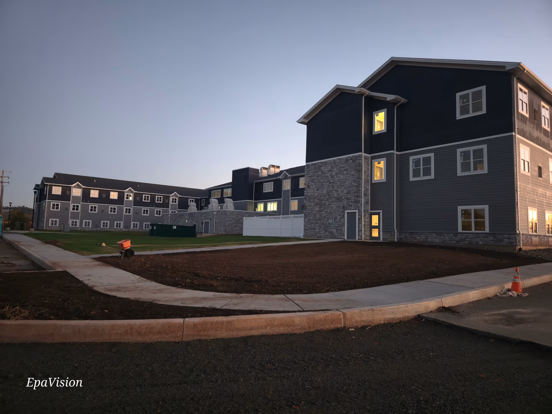 Exterior view of The Residence at Boyertown senior living complex at dusk.