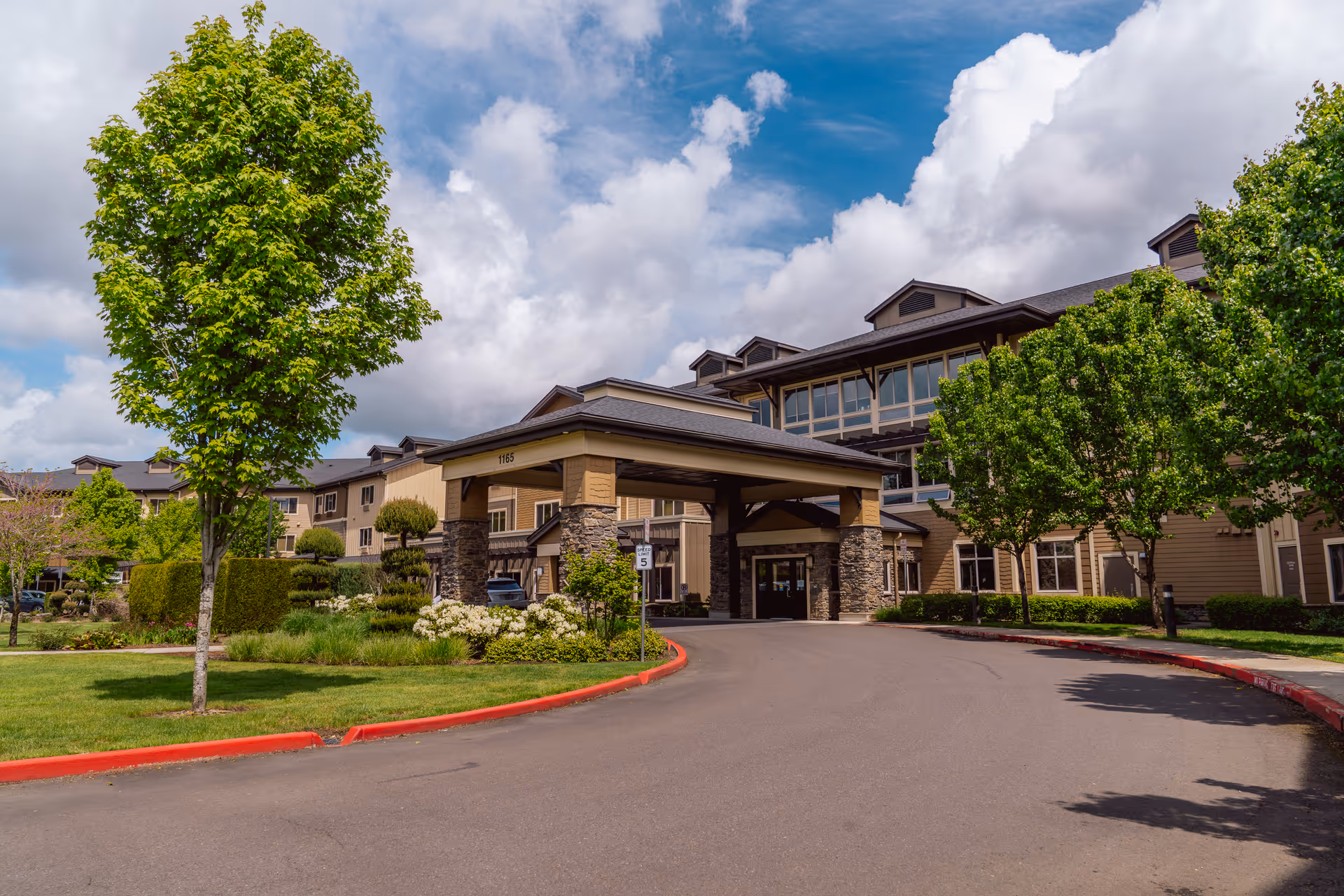 Exterior view of Village at Keizer Ridge Memory Care building with entrance canopy and landscaping