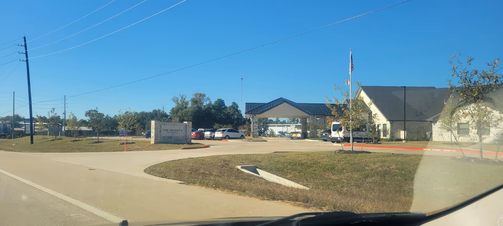 Exterior view of The Heights of Magnolia with entrance canopy and parking lot.