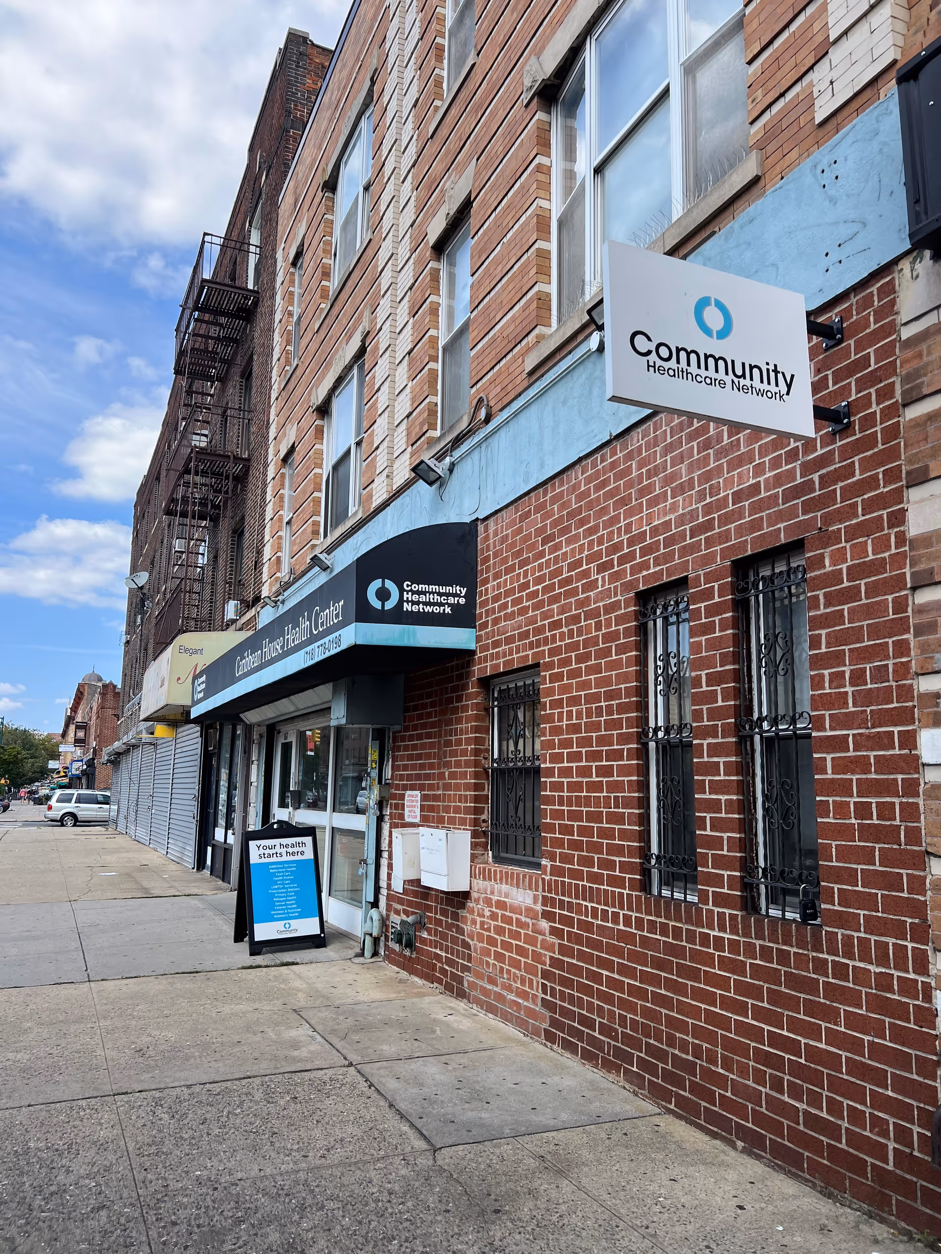 Brick building exterior with Community Healthcare Network sign and storefront windows.
