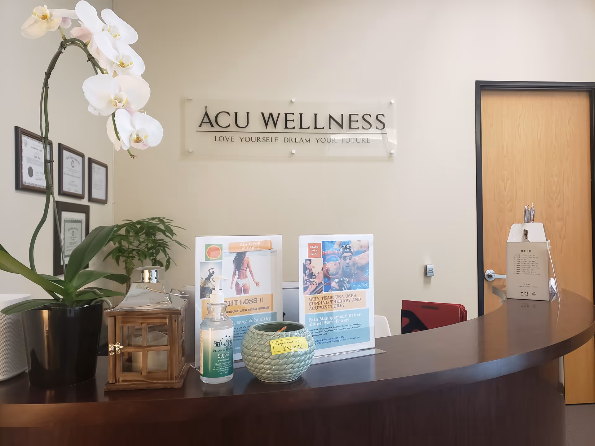 Reception desk in a senior care facility lobby with plants and brochures.
