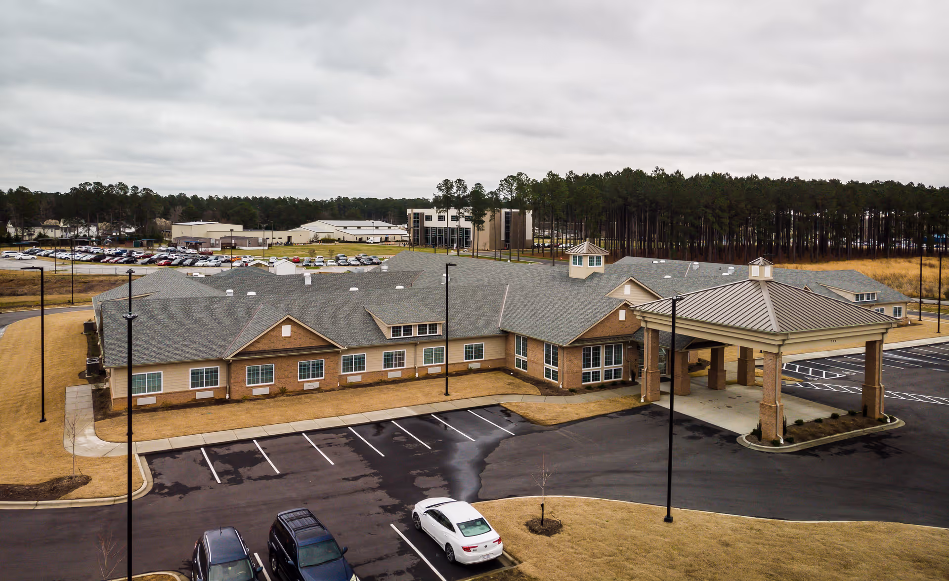 Exterior view of The Landings of Smithfield showing a covered entrance and parking lot.