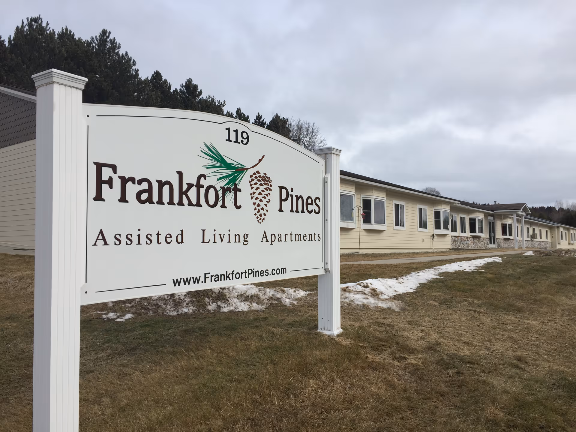 Exterior view of Frankfort Pines Assisted Living sign and front building.