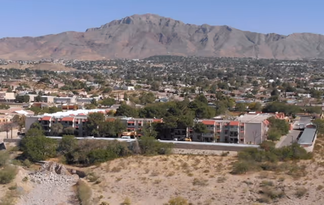 Aerial view of Good Samaritan Society White Acres facility with desert landscape and mountains.